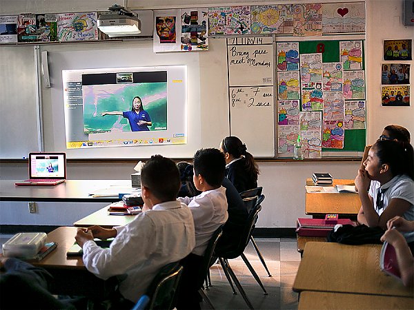 Students in a classroom watching Aquarium led video conference