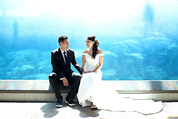 Smiling wedding couple in sea lion tunnel